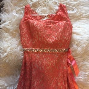 Coral colored prom dress.